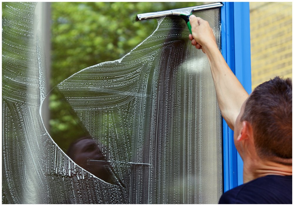 Window washer cleaning windows